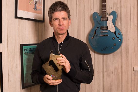 Noel Gallagher with his Official Number 1 Album Award for Who Built The Moon? (Credit: OfficialCharts.com)