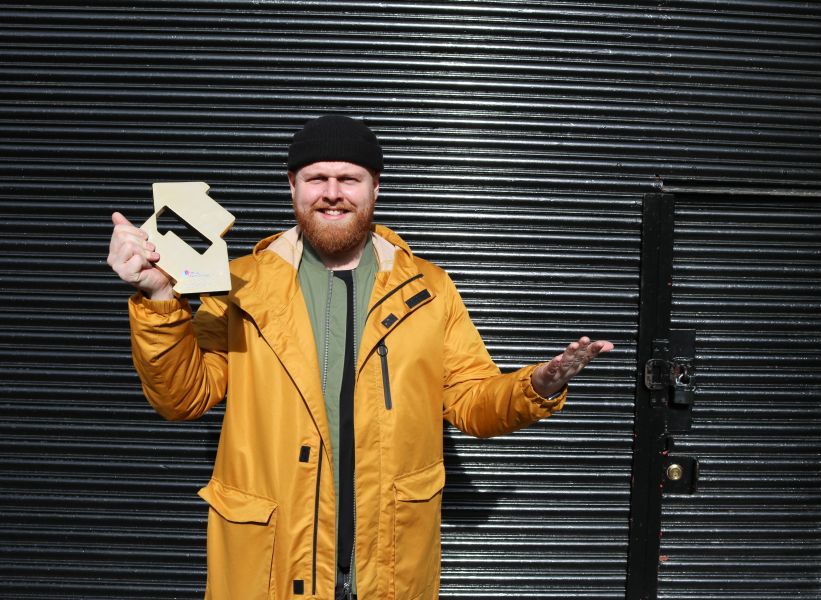 Tom Walker with his Official Number 1 Album Award for What A Time To Be Alive (Credit: OfficialCharts.com)